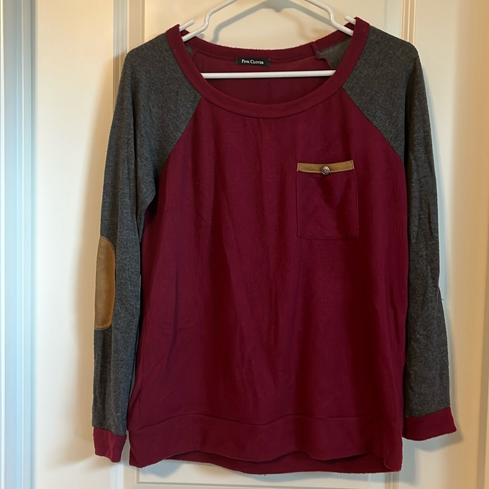 Pink Clover wine and gray sweater with brown packets on elbows